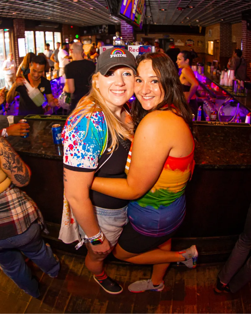 man poses for a photo at the pride bar crawl