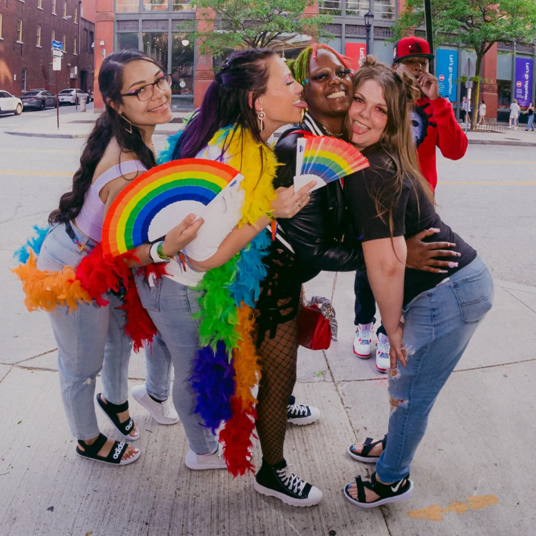 group of friends outside the bar dressed in rainbow for the pride bar crawl